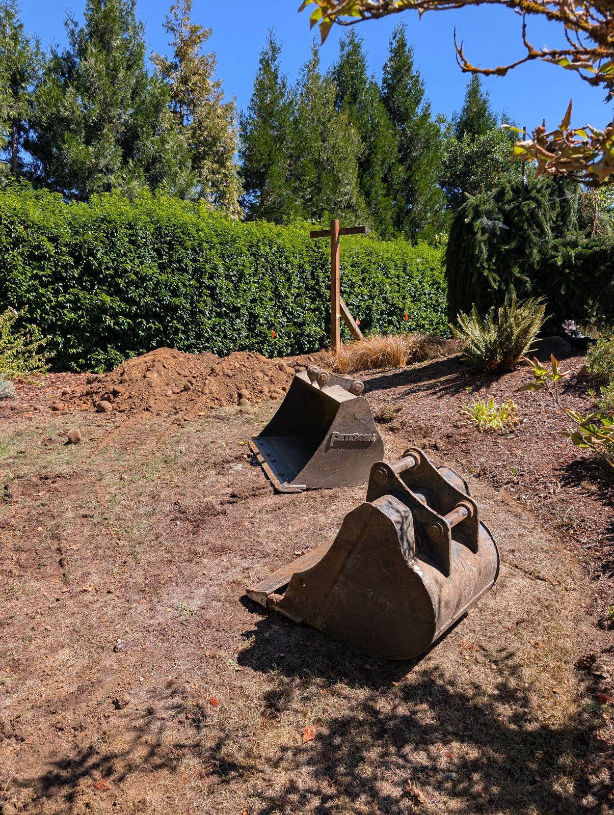 Equipment staged near the hedge line